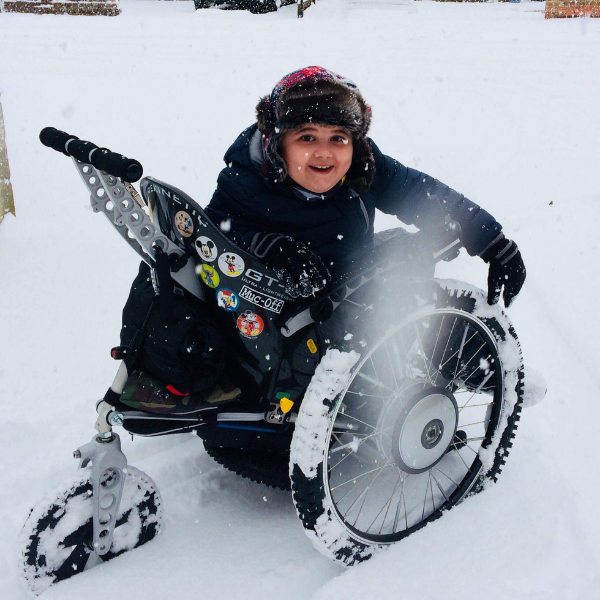 boy-enjoying-snow-in-off-road-wheelchair