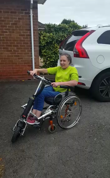Happy customer Taryn takes delivery of the Firefly wheelchair power attachment